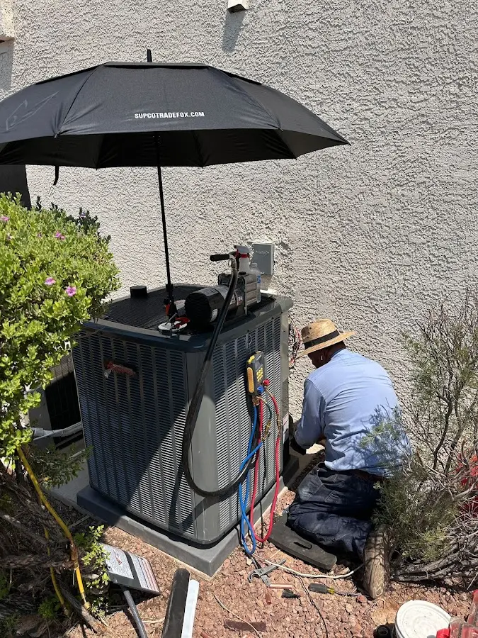HVAC technician performing outdoor AC maintenance in West Palm Beach